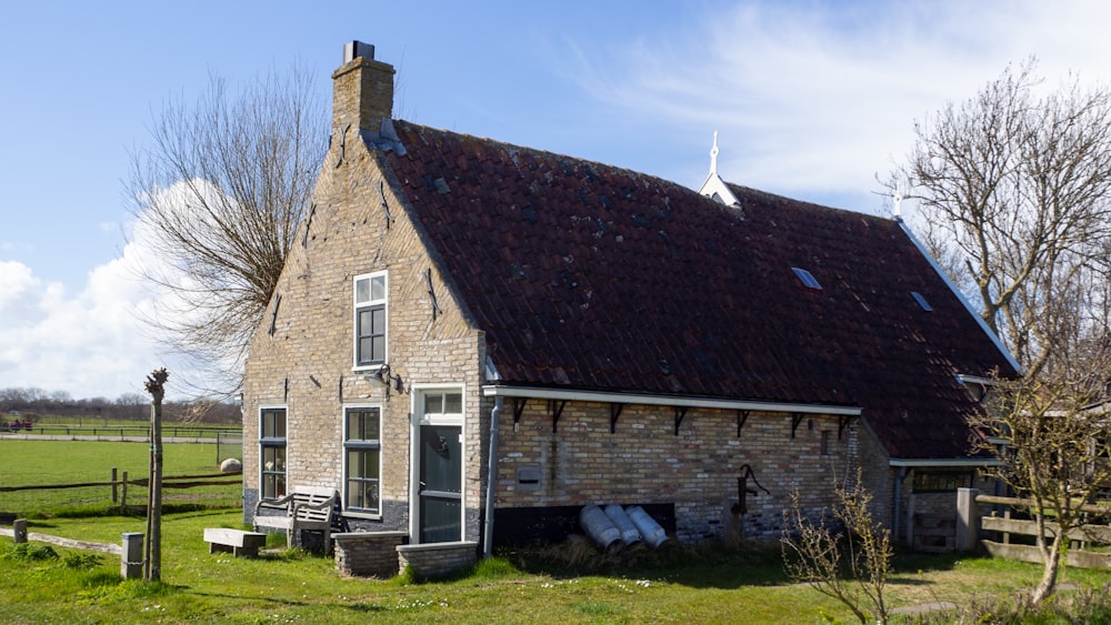 brown brick house on green grass field