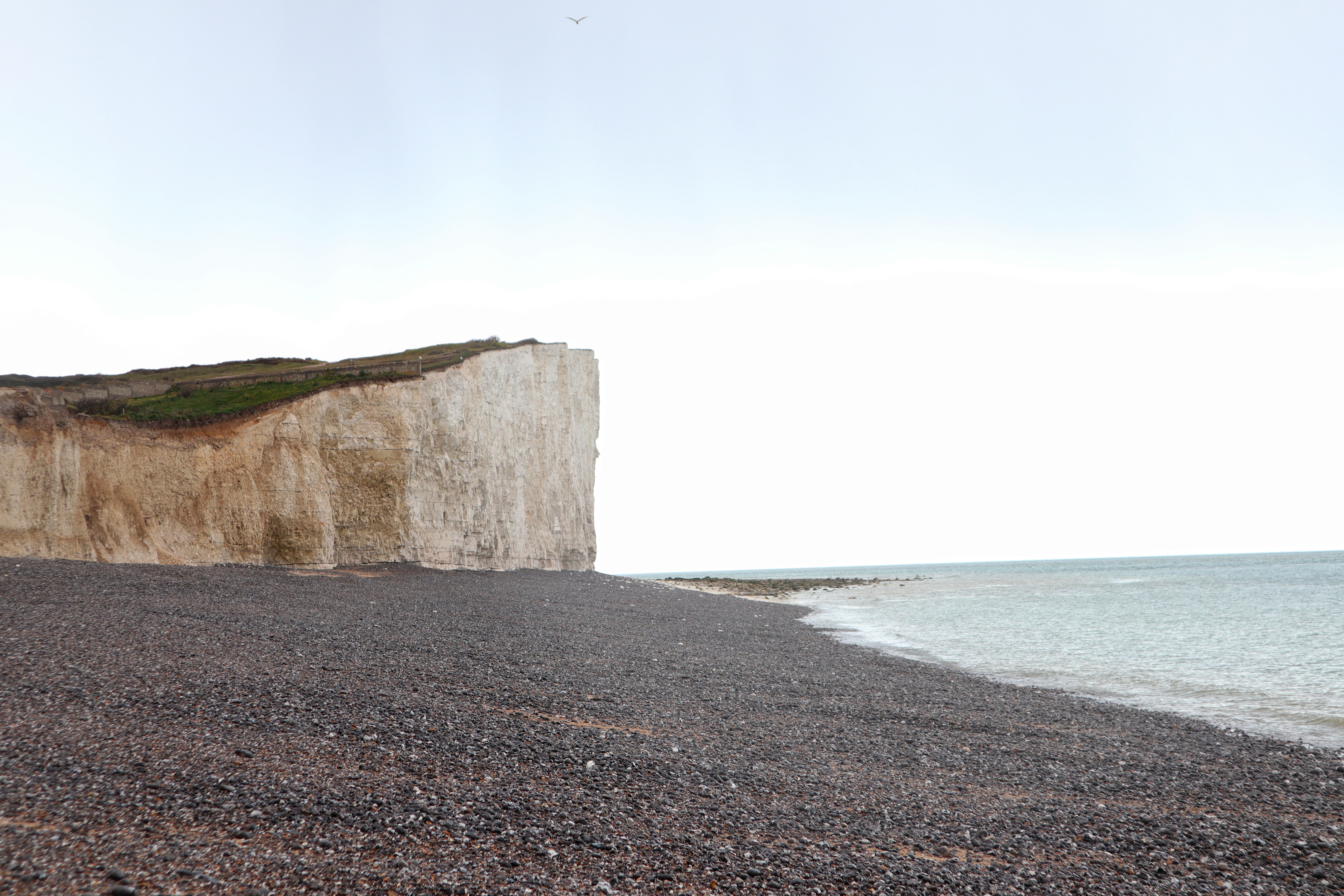 brown rock formation near body of water during daytime