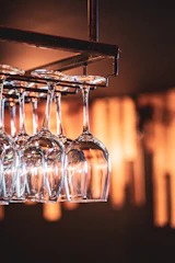 A set of wine glasses with delicate custom etching, catching the light beautifully.