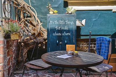 Cozy outdoor seating area with compact furniture next to a tiny home.