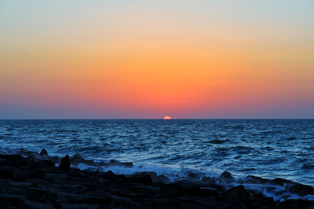 body of water during sunset