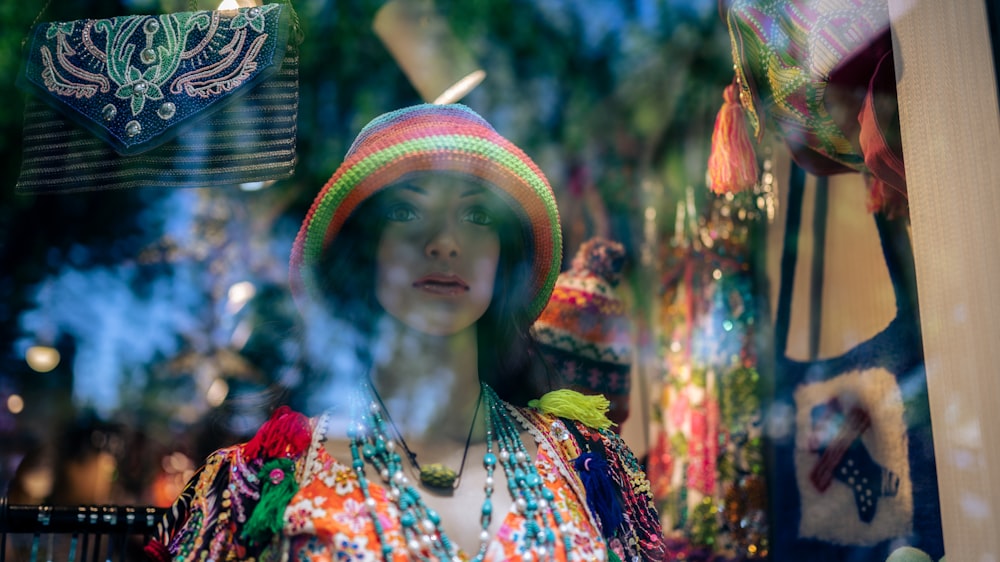 woman in red and blue floral dress wearing brown woven hat