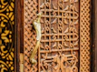 Artisan carving delicate details into a solid wood cabinet door