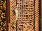 Artisan carving delicate details into a solid wood cabinet door
