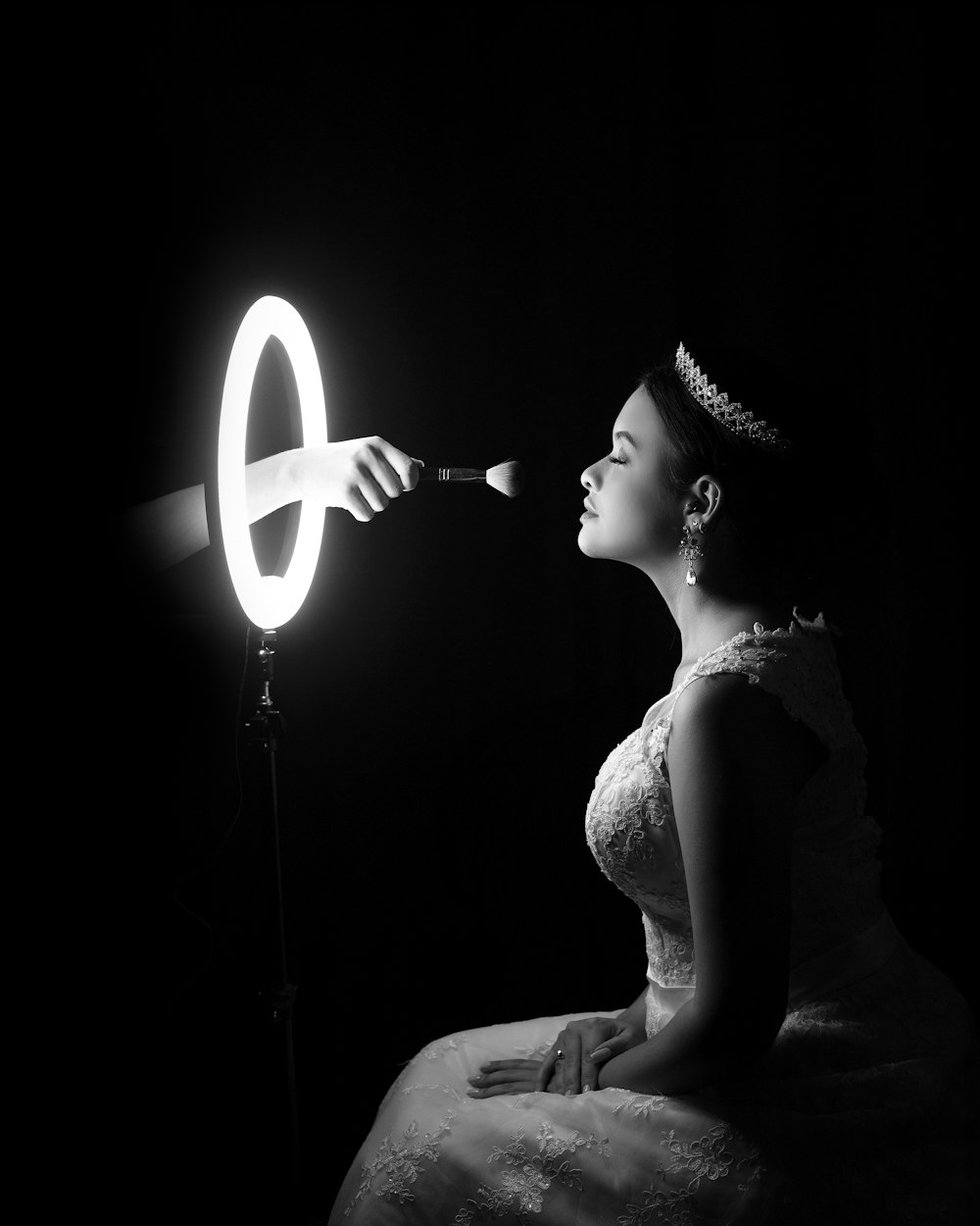 woman in white dress holding white light