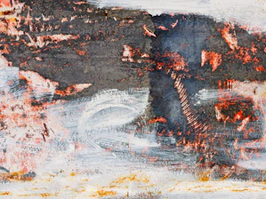 Close-up of a textured abstract painting with soft, earthy tones and subtle brushstrokes.