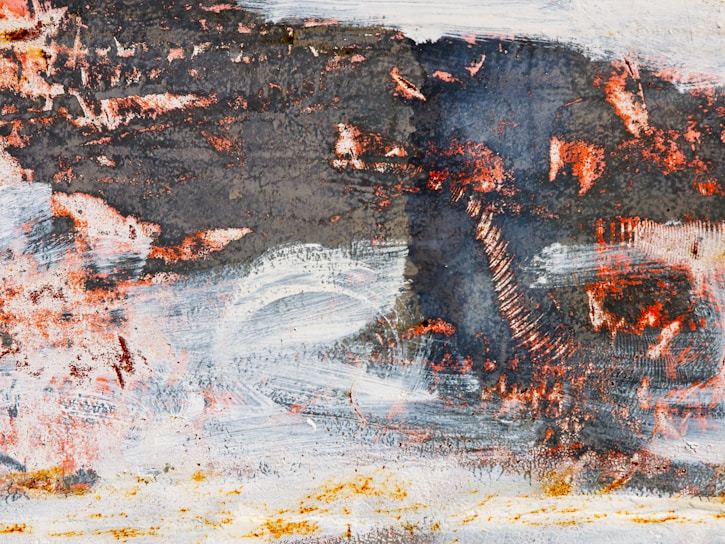 Close-up of a textured abstract painting with rich earth tones and layered brushstrokes.