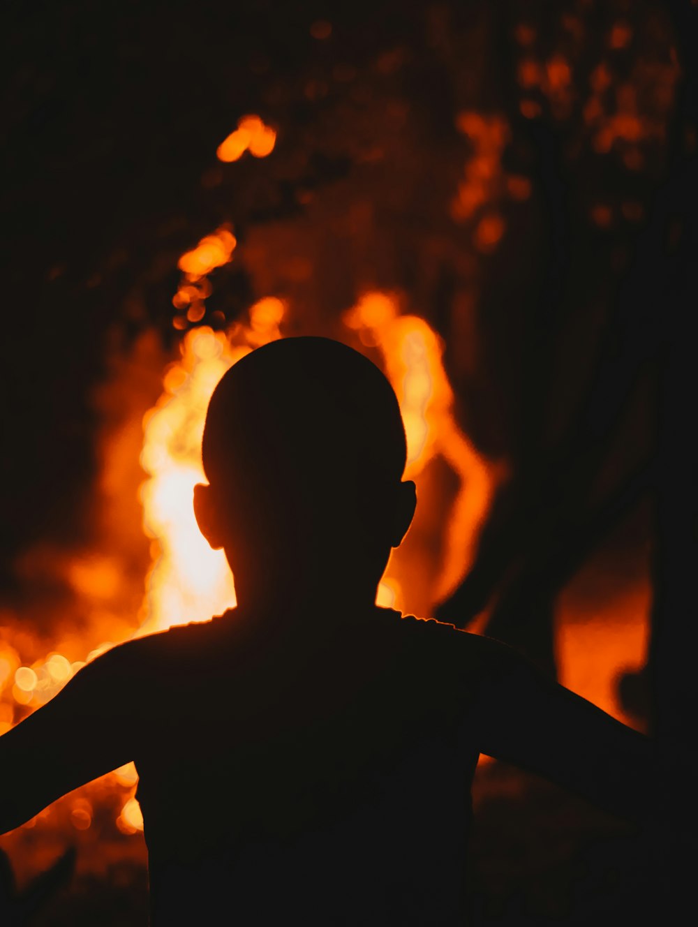 silhouette of man with orange sun behind