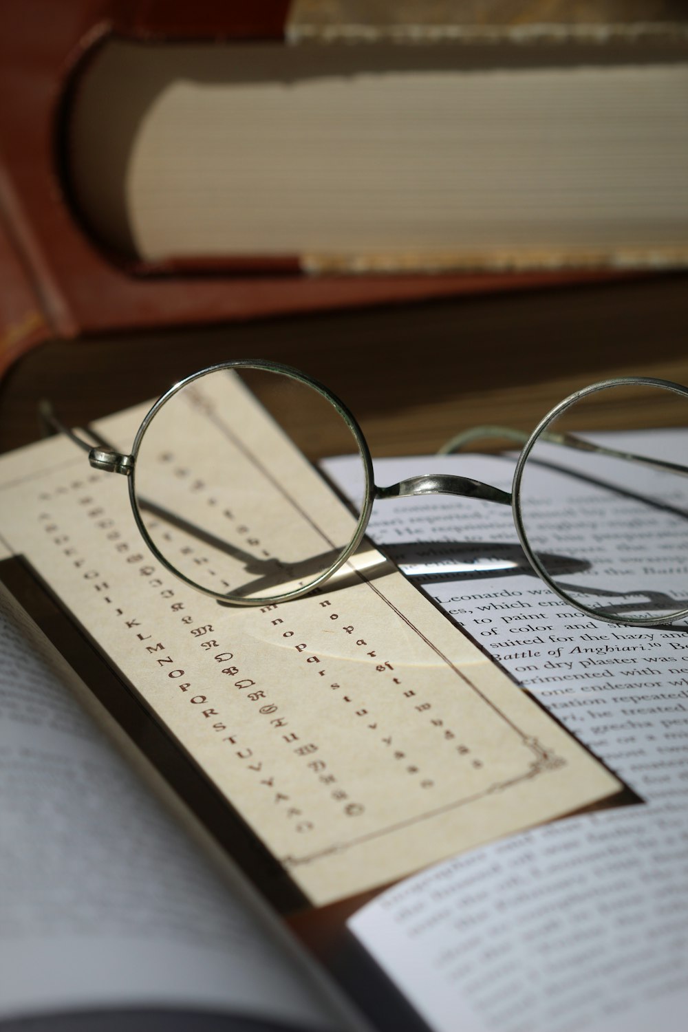 silver framed eyeglasses on white paper