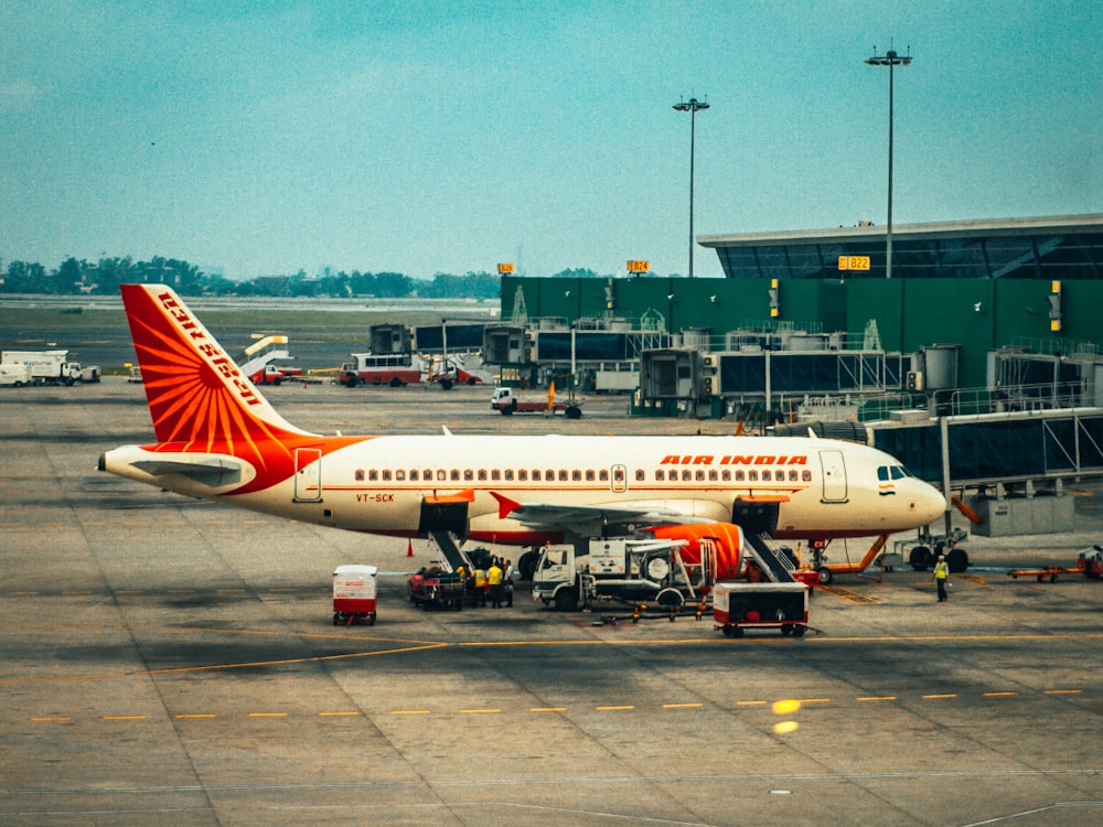 white and red air plane on airport during daytime