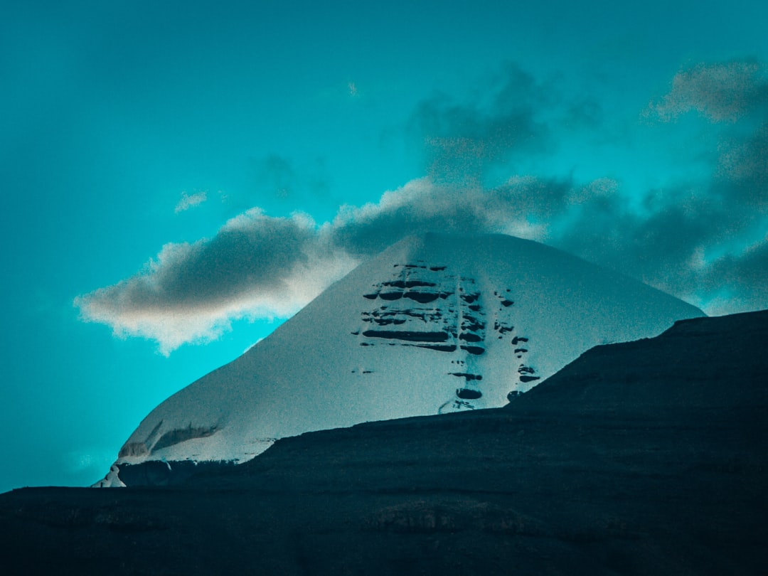 white clouds over mountain during daytime