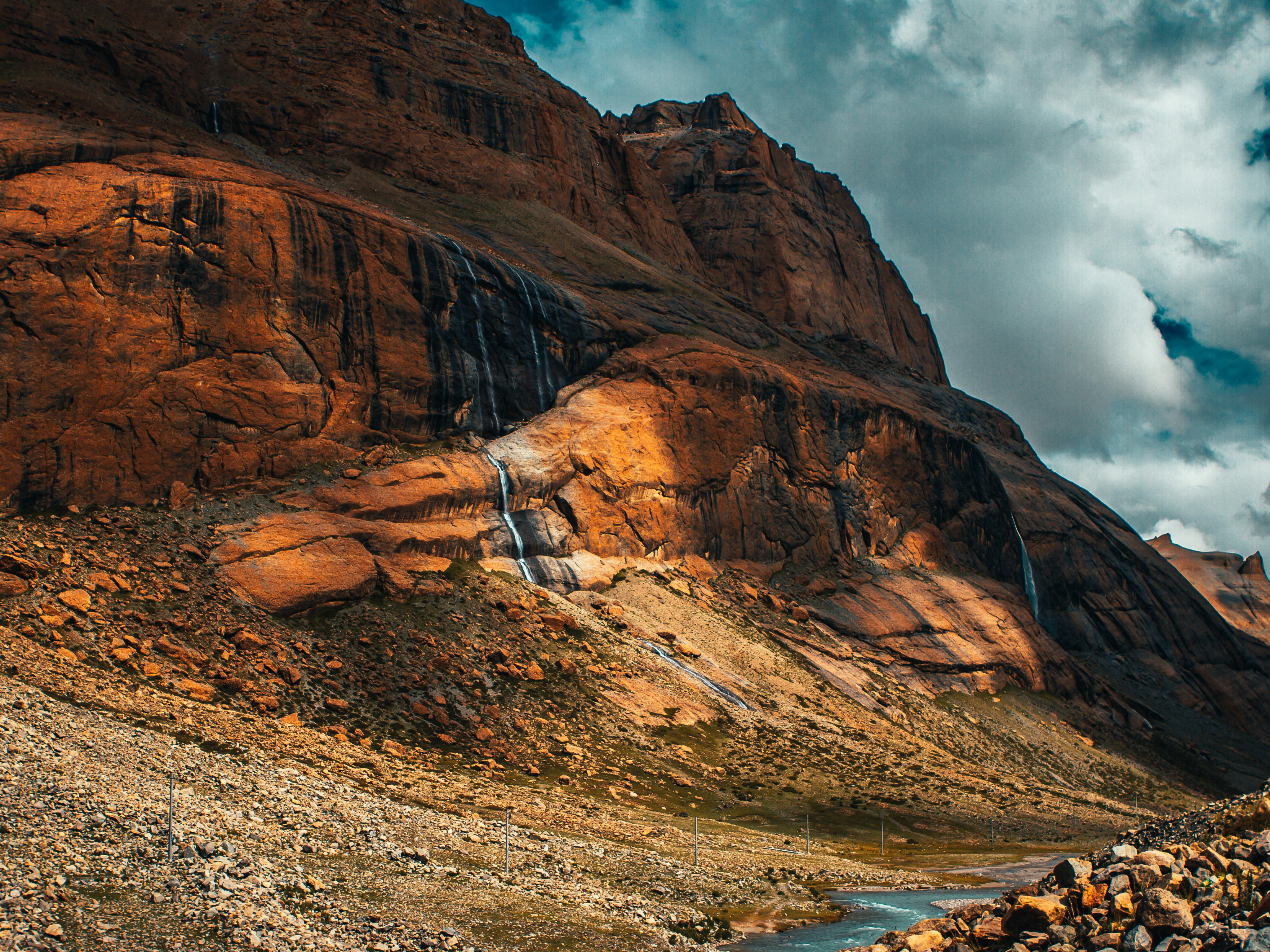 brown rocky mountain under cloudy sky during daytime