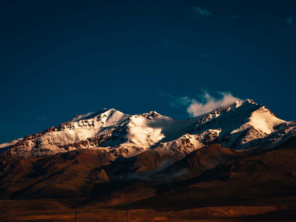 snow covered mountain under blue sky during daytime