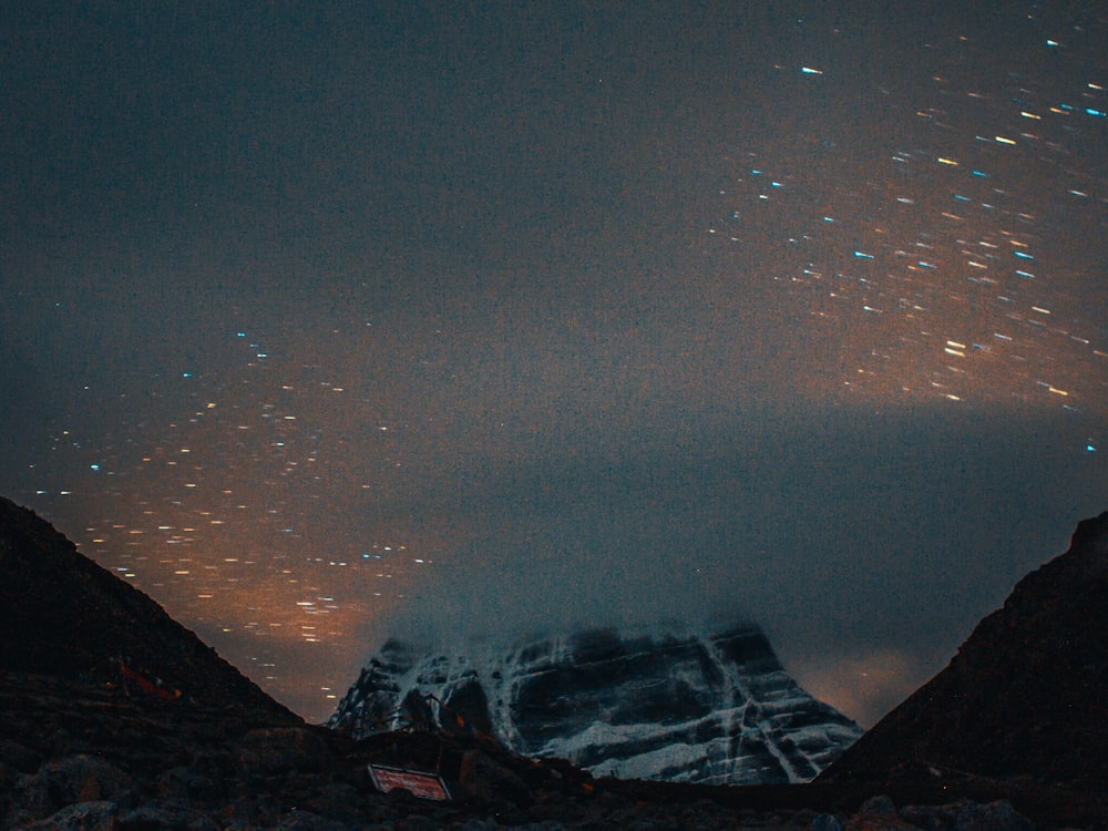 black and white mountains under starry night