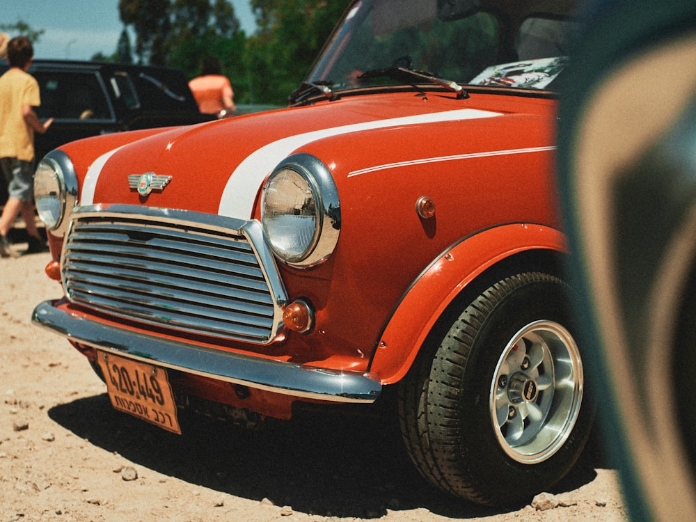 red car on gray asphalt road during daytime