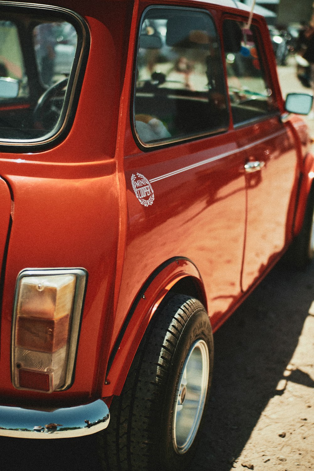 red car on gray asphalt road during daytime