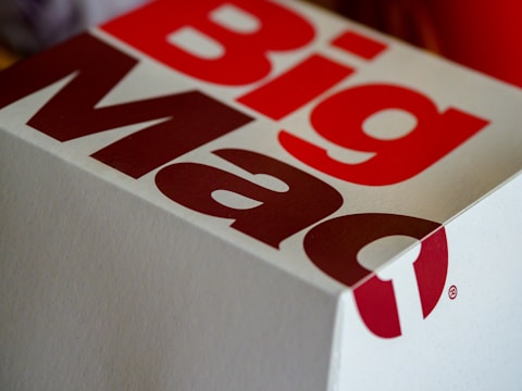 A close-up of a Big Mac packaging box with bold red and white lettering, showcasing part of the logo and design.