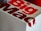A close-up of a Big Mac packaging box with bold red and white lettering, showcasing part of the logo and design.