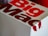 A close-up of a Big Mac packaging box with bold red and white lettering, showcasing part of the logo and design.