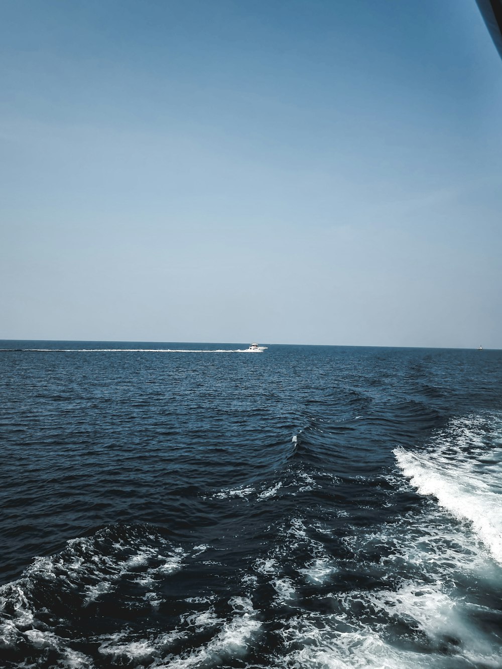 ocean waves under blue sky during daytime