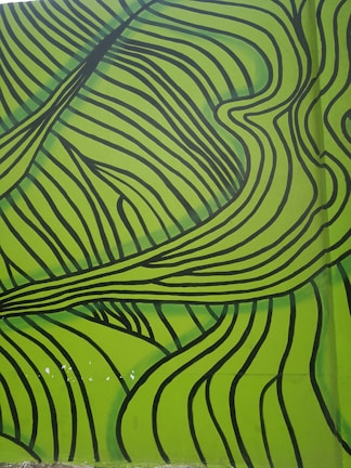 A vibrant vertical mural of a forest wrapping around a living room wall.