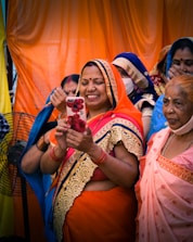 woman in orange dress holding ice cream