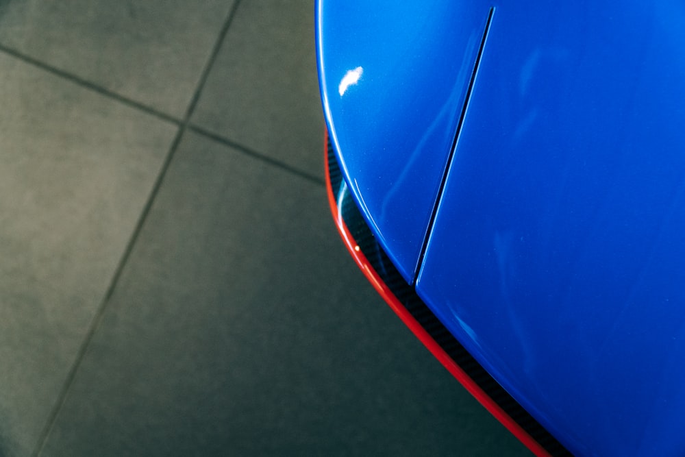 blue car on gray floor tiles