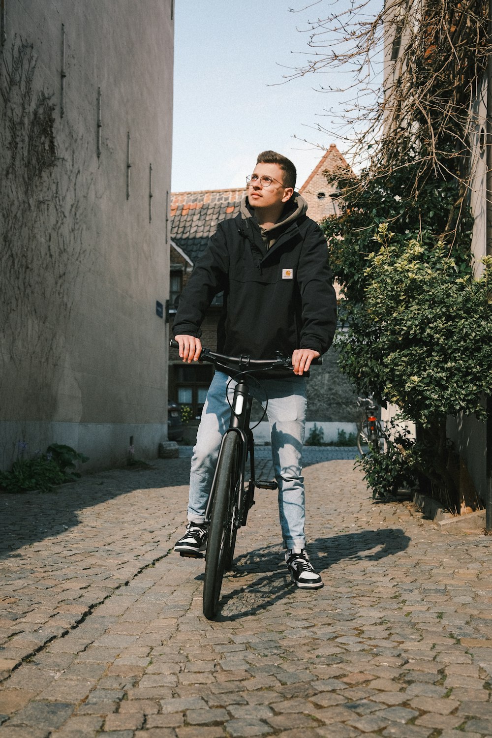 man in black jacket riding bicycle