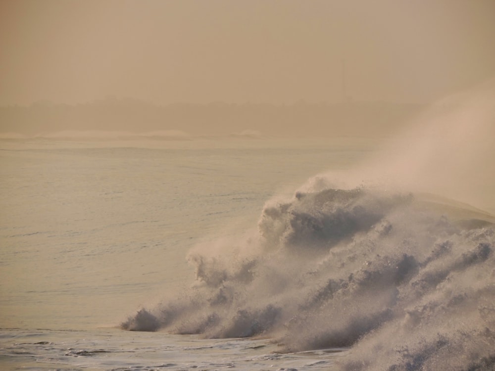 ocean waves crashing on shore during daytime