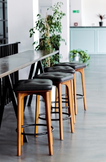 black leather padded brown wooden chairs