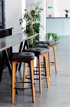 black leather padded brown wooden chairs