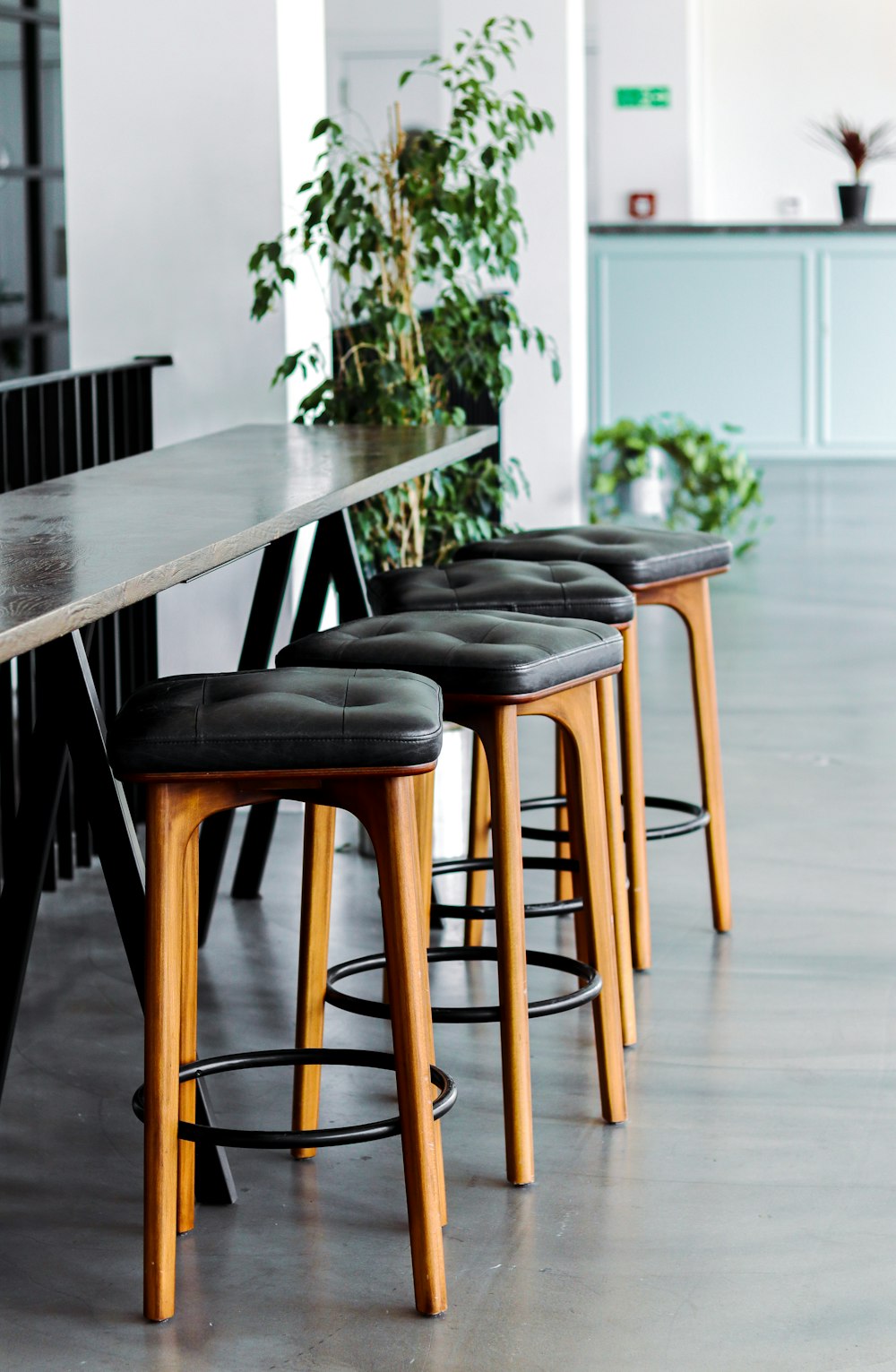 black leather padded brown wooden chairs