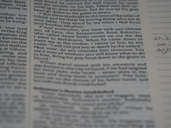 Close-up of a legal transcript document with highlighted text on a desk.