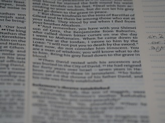 A close-up view of a page from a book or document, featuring printed English text with a portion of handwritten notes in the margins. The text appears to be formatted in paragraphs with some bolded headings.