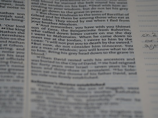 A close-up view of a page from a book or document, featuring printed English text with a portion of handwritten notes in the margins. The text appears to be formatted in paragraphs with some bolded headings.