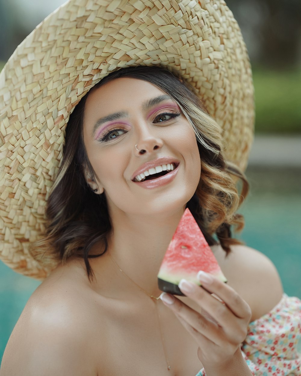 woman in brown sun hat holding watermelon