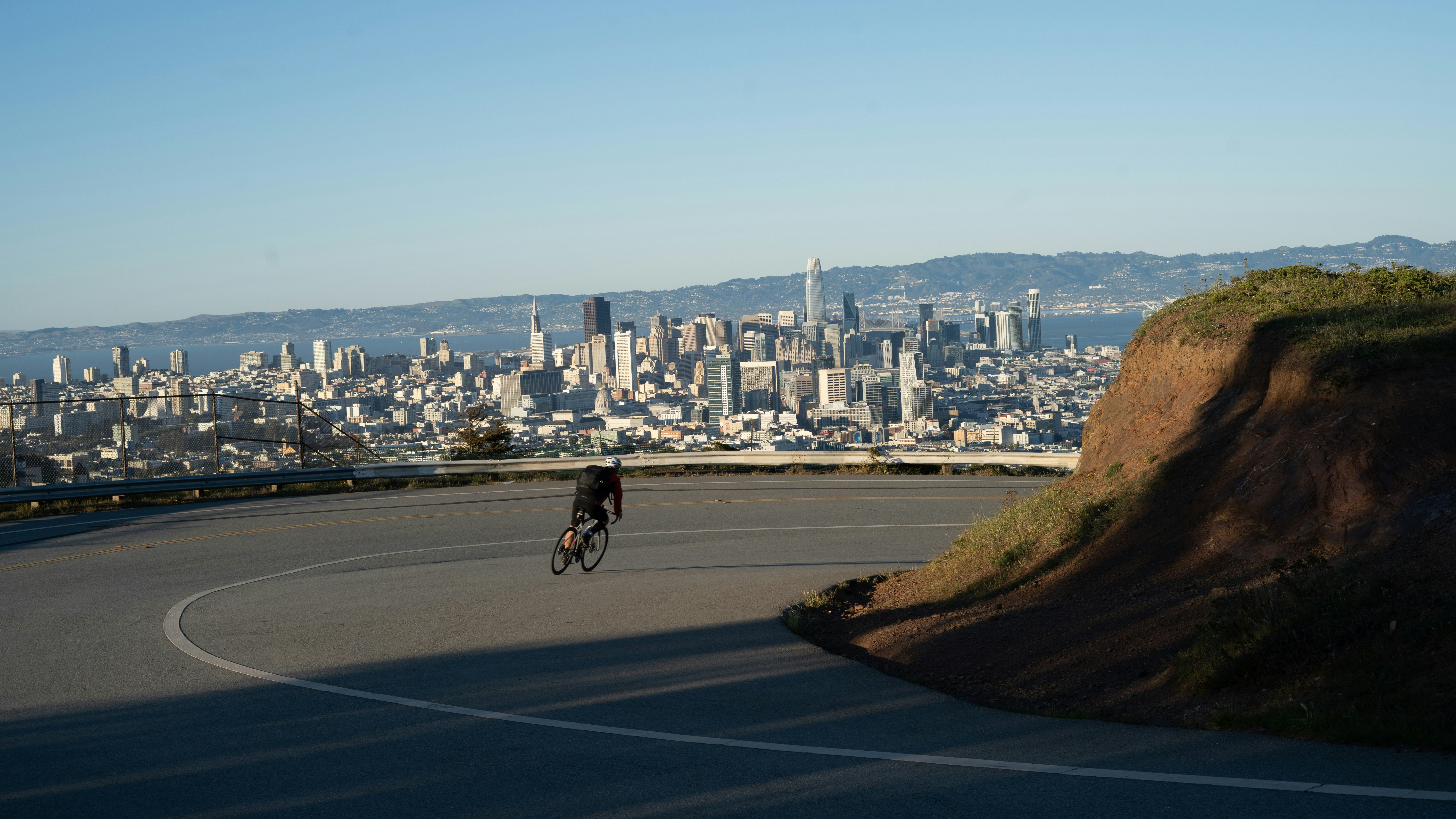 man in black shirt riding bicycle on road during daytime