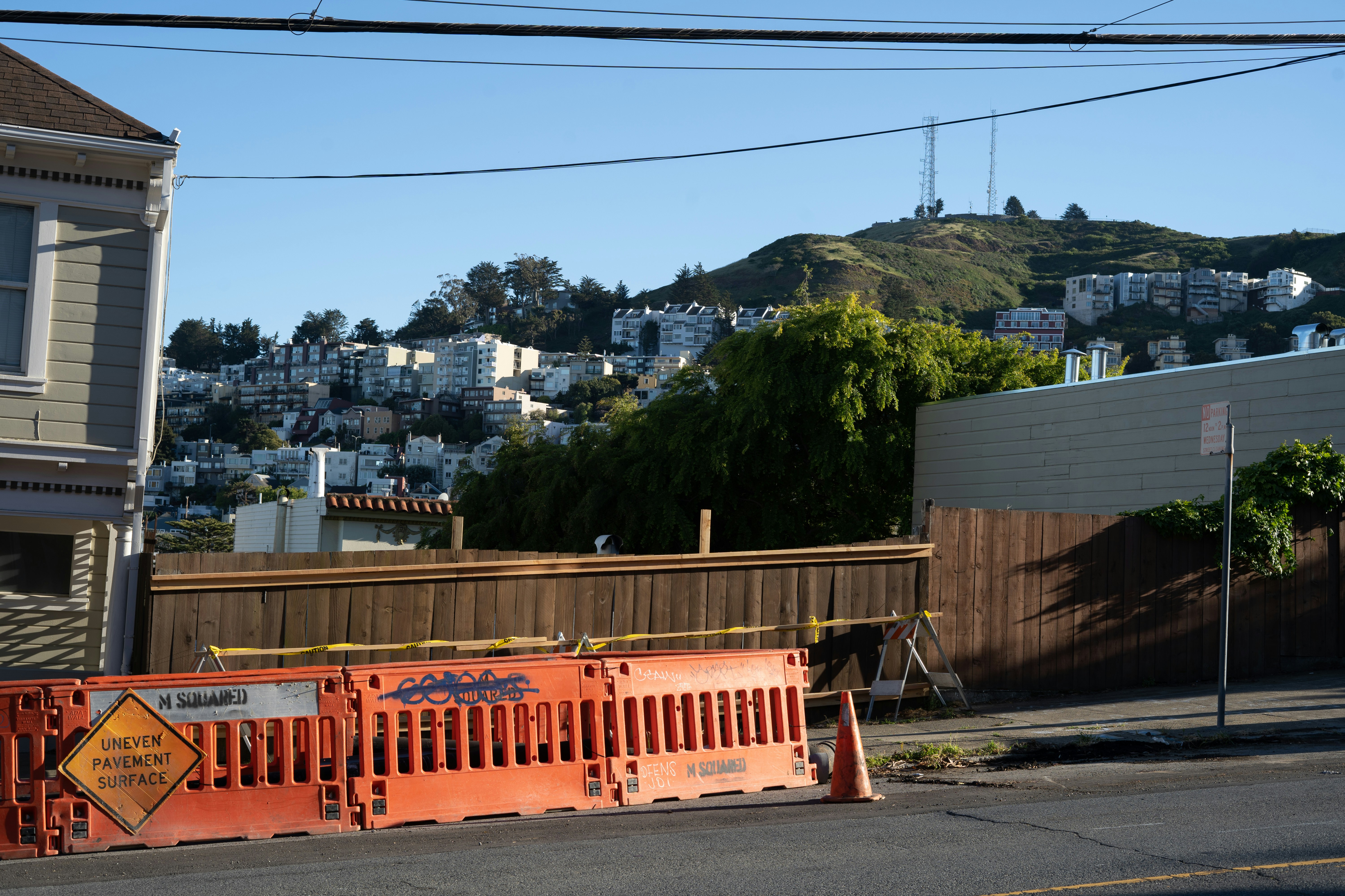 brown wooden fence near green trees during daytime