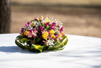 A close-up of a beautifully arranged wedding bouquet resting on a vintage table.