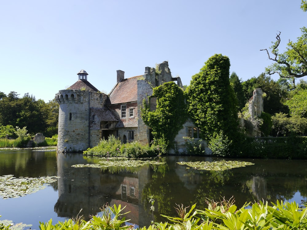 gray concrete building near green trees and body of water during daytime