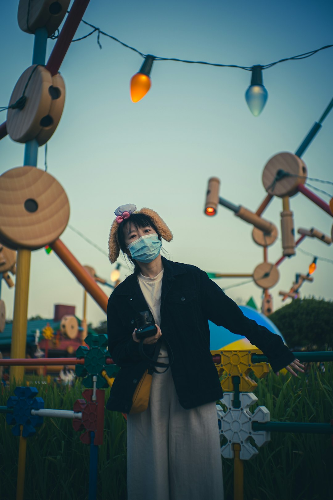 woman in black blazer holding balloons