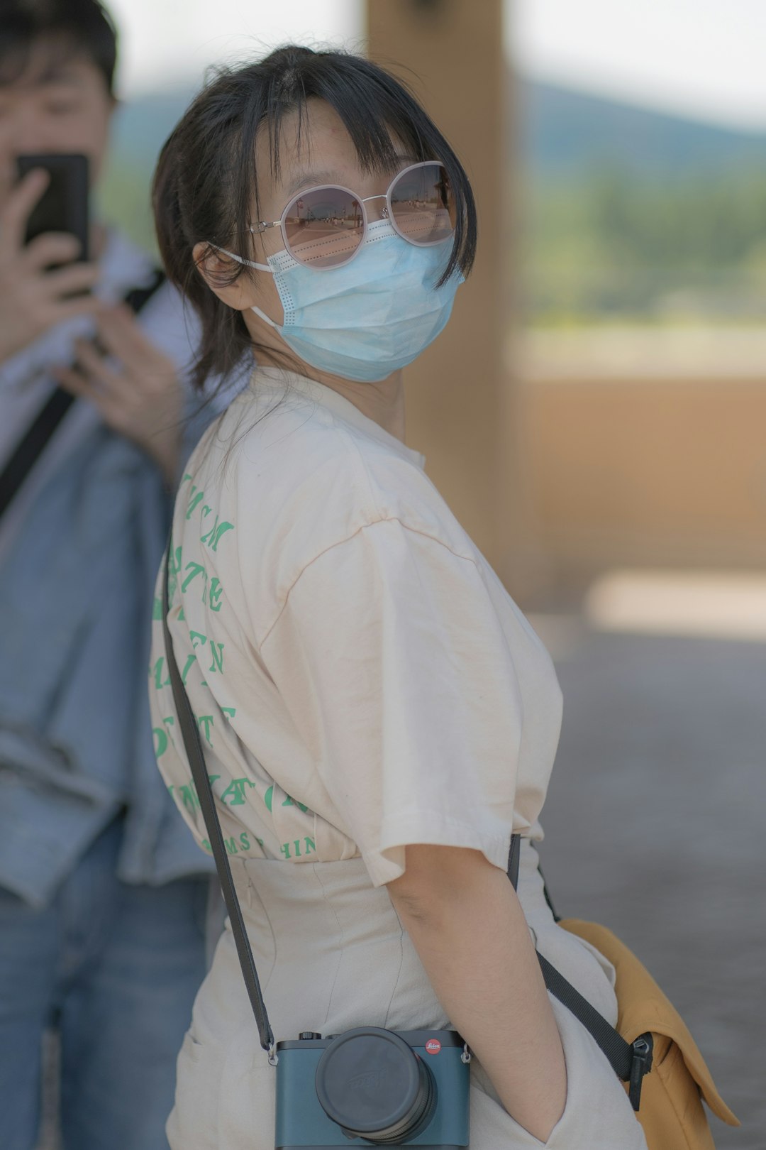 woman in white t-shirt wearing white framed sunglasses
