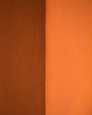 orange wall paint near brown wooden table