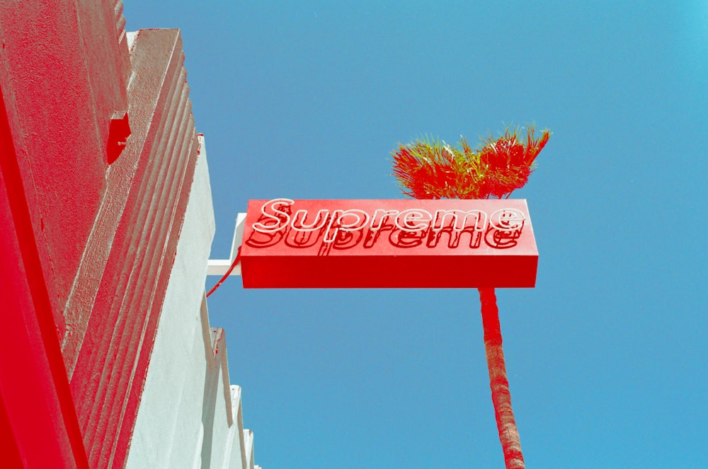 a red sign hanging from the side of a building