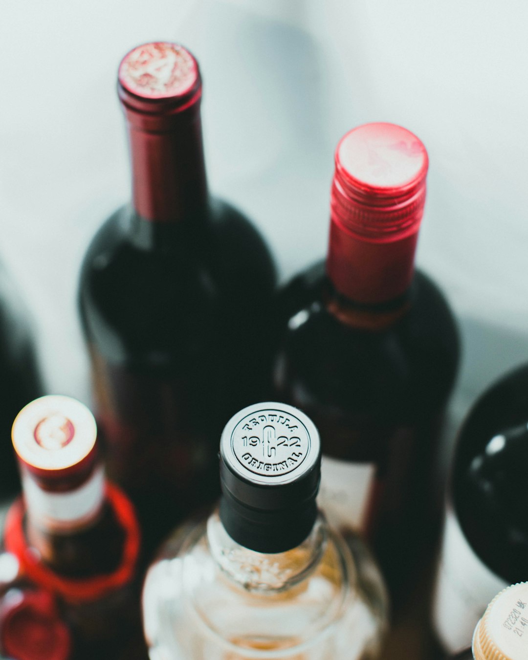 black glass bottles on white table