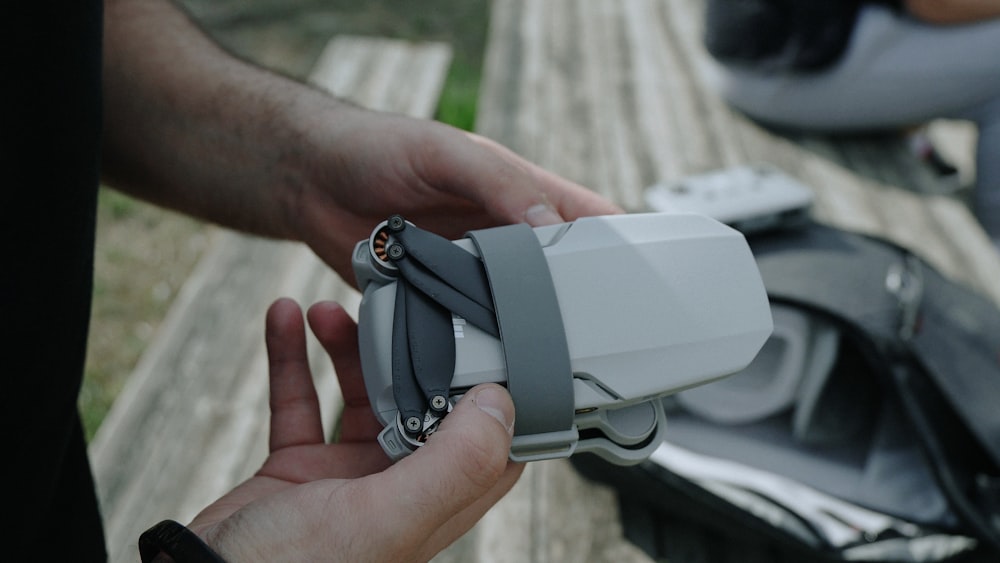 person holding silver and black car key