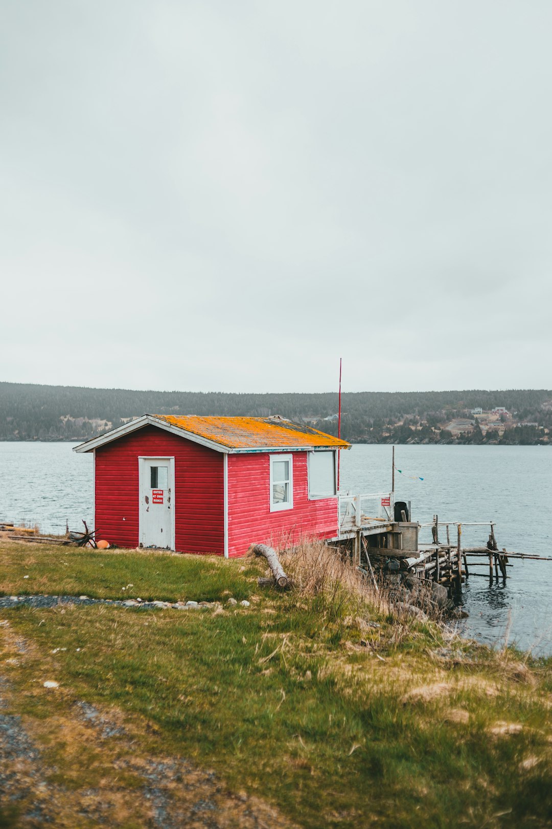 red and white house near body of water during daytime