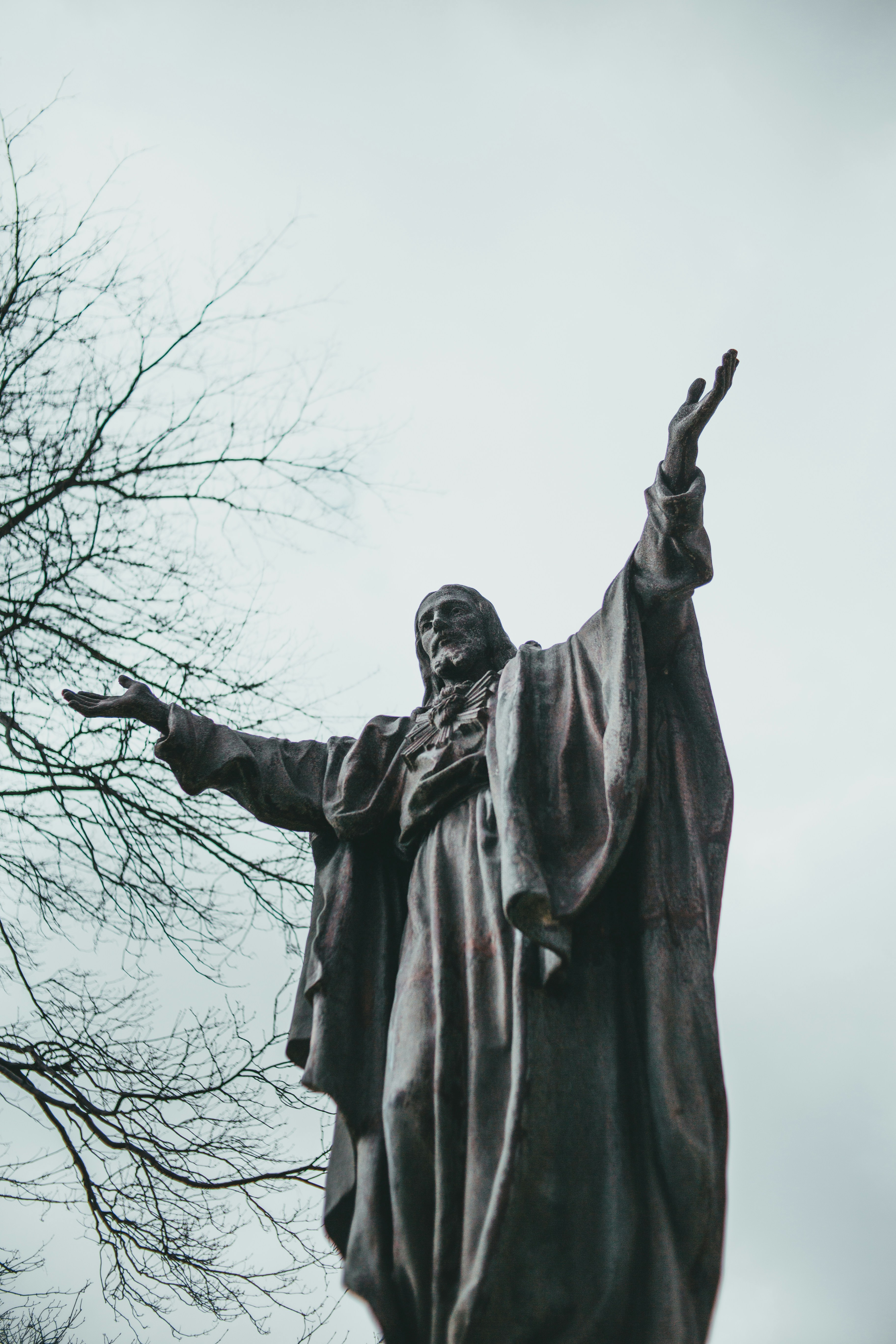 angel statue under white sky during daytime