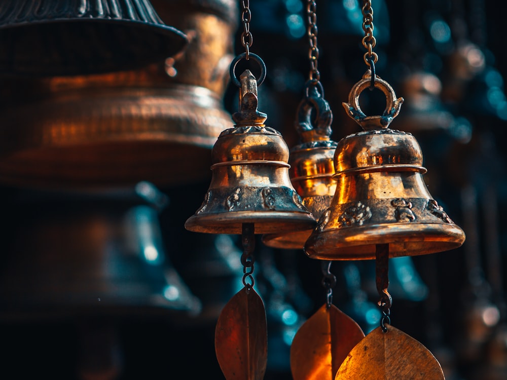 gold bell hanging on brown wooden wall