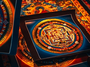 A collection of intricate, colorful mandala artworks, featuring symmetrical geometric patterns with vibrant hues of red, blue, and gold. Each piece displays a complex design, evoking a sense of spiritual and artistic expression.